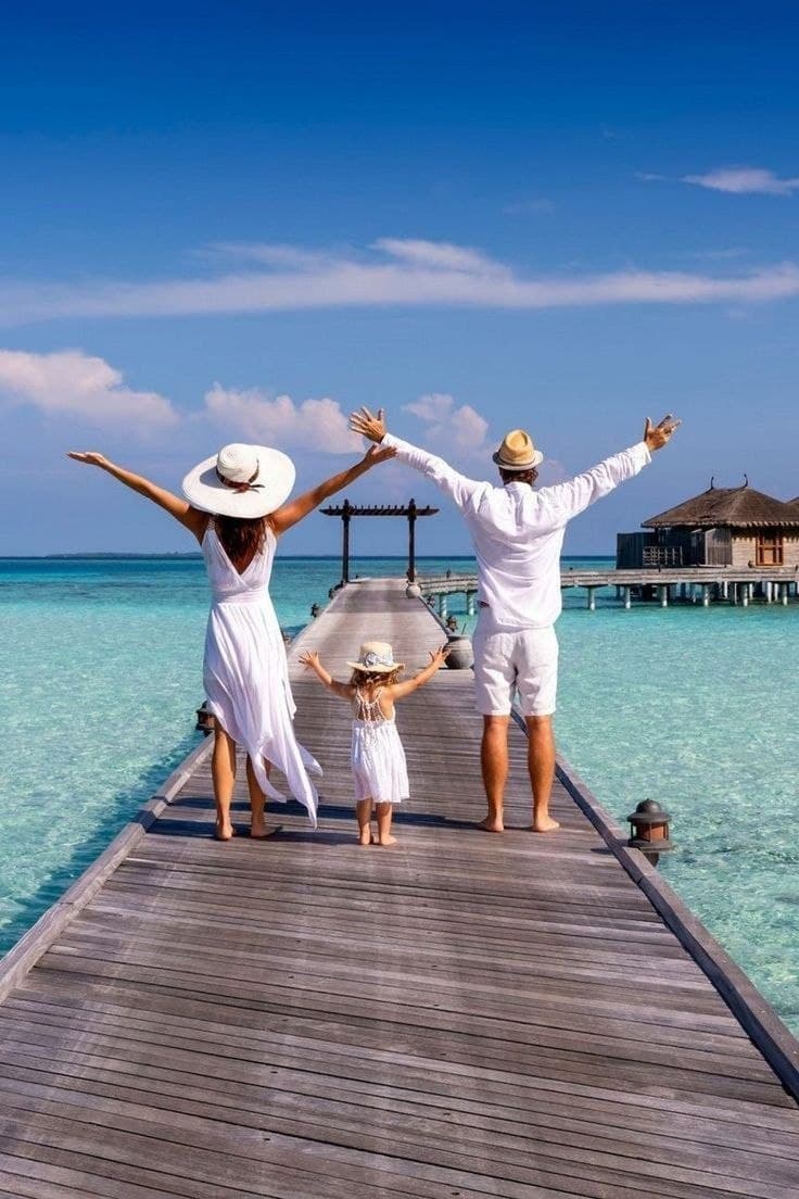 A family celebrating on a pier over turquoise water